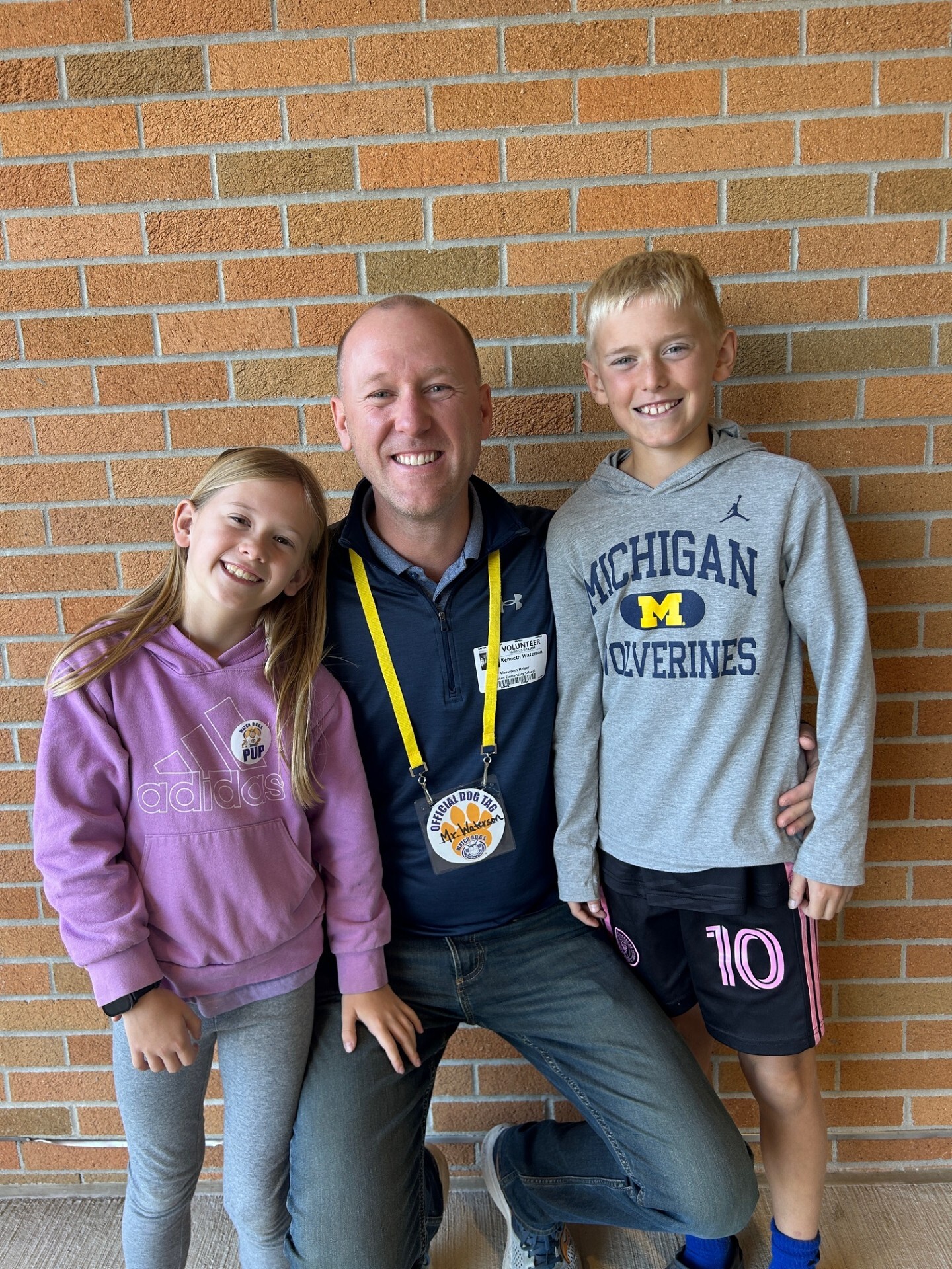 Smiling Dad poses with his two students